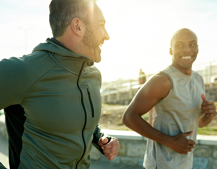 Two men running alongside