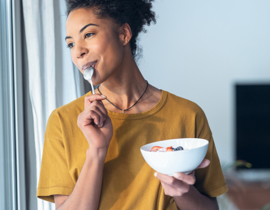 Woman eats cereal. 