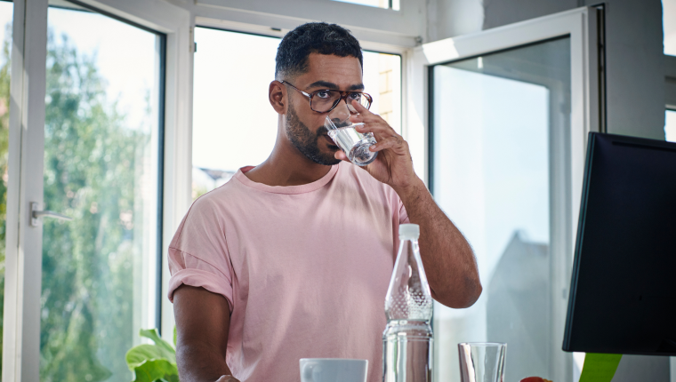 Man drinks water for an ACR kidney test.