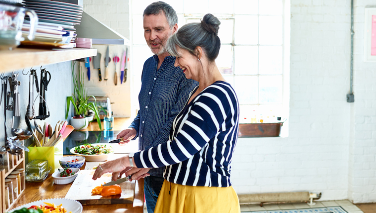 Man and woman prepare healthy food.