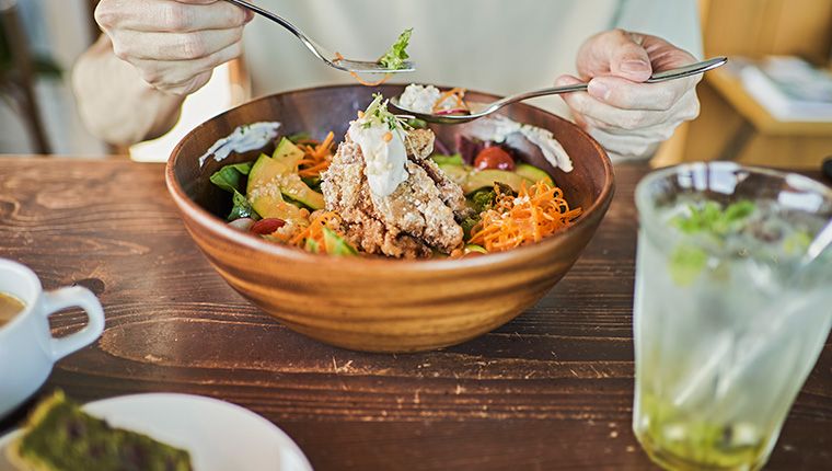 Man eating nourishing salad meal that meets vitamin and nutrient levels